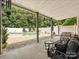 Inviting outdoor patio with shaded seating area overlooking a pool, perfect for relaxing and entertaining at 1842 Caroline Way, Fort Mill, SC 29715