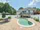 Beautifully landscaped backyard featuring a sparkling pool, patio area, and lush greenery, creating a private oasis at 1842 Caroline Way, Fort Mill, SC 29715