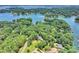 Stunning aerial view of lakefront homes surrounded by lush trees and sparkling blue waters at 19900 Stough Farm Rd, Cornelius, NC 28031