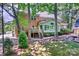 Spacious backyard featuring a deck, sunroom, mature trees, and a serene rock garden at 19900 Stough Farm Rd, Cornelius, NC 28031