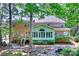 Expansive brick home with a back deck, sunroom, lush greenery, and serene rock garden at 19900 Stough Farm Rd, Cornelius, NC 28031