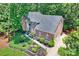 Impressive brick home with manicured landscaping, fountain, and three-car garage nestled in lush greenery at 19900 Stough Farm Rd, Cornelius, NC 28031
