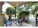 Relaxing back porch offers a patio table and chairs surrounded by lush greenery at 2620 Park Rd # F, Charlotte, NC 28209