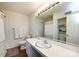Well-lit bathroom features a long vanity with white countertops, a mirror, and a shower-tub combination at 2620 Park Rd # F, Charlotte, NC 28209