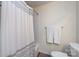 Neat bathroom showcasing a shower with a curtain and white towels on a rack above the toilet at 2620 Park Rd # F, Charlotte, NC 28209
