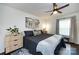 Bright bedroom boasts a ceiling fan, accent pillows, and natural light from the window at 2620 Park Rd # F, Charlotte, NC 28209