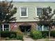 Building entrance features a brick facade, awning, American flag, and trimmed shrubbery at 2620 Park Rd # F, Charlotte, NC 28209