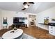 Open-concept living room with a TV and a connection to the dining area at 2620 Park Rd # F, Charlotte, NC 28209