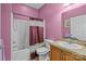 Cozy pink bathroom featuring a combination tub and shower, toilet, and vanity with a warm-toned countertop at 307 Nc Hwy 49 S Hwy, Richfield, NC 28137
