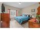 Inviting bedroom with neutral walls, tiled floor, and a comfortably sized bed with blue bedding and warm wood furnishings at 307 Nc Hwy 49 S Hwy, Richfield, NC 28137