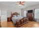 Spacious bedroom featuring a dark wood bed set, wood flooring, and two windows for natural light at 307 Nc Hwy 49 S Hwy, Richfield, NC 28137