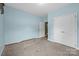 Open bedroom with light-blue walls, carpeted floors, and a walk-in closet, offering versatile living space at 307 Nc Hwy 49 S Hwy, Richfield, NC 28137