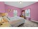 Cozy bedroom with pink walls, a floral-patterned quilt, and matching curtains, creating a charming and comfortable atmosphere at 307 Nc Hwy 49 S Hwy, Richfield, NC 28137
