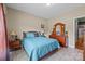 Bright bedroom with a soft blue bed, coordinated wood furniture, and large window with sheer curtains at 307 Nc Hwy 49 S Hwy, Richfield, NC 28137
