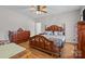 Spacious bedroom featuring hardwood floors, ceiling fan, and complemented by wooden dresser and wardrobe at 307 Nc Hwy 49 S Hwy, Richfield, NC 28137