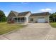 Charming home with stone accents, covered porch, and an attached two-car garage on a sunny day at 307 Nc Hwy 49 S Hwy, Richfield, NC 28137