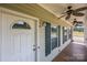 Inviting front porch with ceiling fans, wooden floors, and white trim at 307 Nc Hwy 49 S Hwy, Richfield, NC 28137