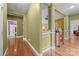 Hallway featuring hardwood floors and decorative columns, connecting the living spaces at 307 Nc Hwy 49 S Hwy, Richfield, NC 28137