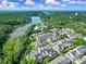 Panoramic aerial view of a neighborhood near a large lake surrounded by lush greenery and clear skies at 329 Wave Crest Dr, Tega Cay, SC 29708