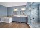 Bathroom with dual sinks, granite countertops, soaking tub and large glass shower at 329 Wave Crest Dr, Tega Cay, SC 29708