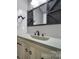 Bathroom with a modern sink, wood cabinets, and black sliding barn door mirror at 329 Wave Crest Dr, Tega Cay, SC 29708