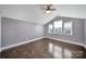 Cozy bedroom with hardwood floors, vaulted ceiling, and abundant natural light from multiple windows at 329 Wave Crest Dr, Tega Cay, SC 29708
