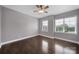 Well-lit bedroom with hardwood floors and two bright windows at 329 Wave Crest Dr, Tega Cay, SC 29708