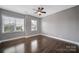 Neutral bedroom with ceiling fan and natural light from two large windows at 329 Wave Crest Dr, Tega Cay, SC 29708