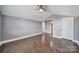 Bedroom with hardwood floors, a ceiling fan, and a walk-in closet at 329 Wave Crest Dr, Tega Cay, SC 29708
