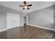 Generously sized bedroom with hardwood floors, closet, and ceiling fan at 329 Wave Crest Dr, Tega Cay, SC 29708