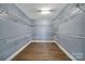 Walk-in closet featuring custom shelving and a hardwood floor at 329 Wave Crest Dr, Tega Cay, SC 29708