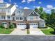 Beautiful townhome with stone accents, two-car garage, and manicured lawn, perfect for comfortable living at 329 Wave Crest Dr, Tega Cay, SC 29708