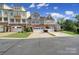 Attractive townhome with a stone and siding exterior, featuring multiple garages and well-maintained landscaping at 329 Wave Crest Dr, Tega Cay, SC 29708