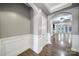 Elegant hallway with wainscoting, hardwood floors, and archway leading to a spacious living area at 329 Wave Crest Dr, Tega Cay, SC 29708