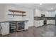 Kitchen area featuring granite countertops, two wine fridges and stainless steel appliances at 329 Wave Crest Dr, Tega Cay, SC 29708