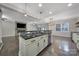 Kitchen featuring an island with granite counters, stainless dishwasher, and views of a living room with fireplace at 329 Wave Crest Dr, Tega Cay, SC 29708