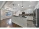 Modern kitchen with island, granite countertops, stainless steel appliances, and open to the dining area at 329 Wave Crest Dr, Tega Cay, SC 29708