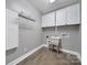 Practical laundry room with overhead storage cabinets and a utility sink at 329 Wave Crest Dr, Tega Cay, SC 29708
