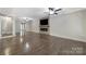 Spacious living room with stone fireplace, ceiling fan, and hardwood floors, perfect for relaxation at 329 Wave Crest Dr, Tega Cay, SC 29708