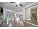 Open-concept living room with hardwood floors, ceiling fans, and seamless flow to kitchen and dining areas at 329 Wave Crest Dr, Tega Cay, SC 29708