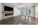 Cozy living room featuring a stone fireplace, modern electric insert, and access to the backyard at 329 Wave Crest Dr, Tega Cay, SC 29708