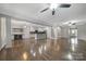 Expansive living room with hardwood floors, wine cooler, and open layout connecting to kitchen and dining at 329 Wave Crest Dr, Tega Cay, SC 29708