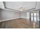 Large main bedroom with tray ceilings, ceiling fan, hardwood floors and an ensuite bathroom at 329 Wave Crest Dr, Tega Cay, SC 29708
