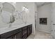 Well-lit bathroom featuring double sinks, dark wood cabinetry, and tile flooring, creating a functional and stylish space at 4022 Perth Rd, Indian Land, SC 29707