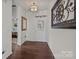 Bright entryway showcasing wood floors, decorative wall art, and a view into an adjacent room at 4022 Perth Rd, Indian Land, SC 29707