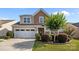 Two-story home featuring manicured landscaping, a two-car garage, and a mix of siding and stone accents on the facade at 4022 Perth Rd, Indian Land, SC 29707