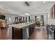 Open-concept kitchen featuring a center island, granite countertops, modern appliances, and hardwood floors at 4022 Perth Rd, Indian Land, SC 29707
