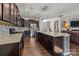 Open kitchen boasts granite countertops, a stainless-steel refrigerator, and a large island perfect for entertaining at 4022 Perth Rd, Indian Land, SC 29707
