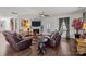 Inviting living room showcasing wood floors, a fireplace, a ceiling fan, and comfortable seating at 4022 Perth Rd, Indian Land, SC 29707