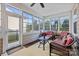 Bright sunroom with floor-to-ceiling windows, wicker furniture, and an inviting atmosphere for relaxation and enjoyment at 4022 Perth Rd, Indian Land, SC 29707